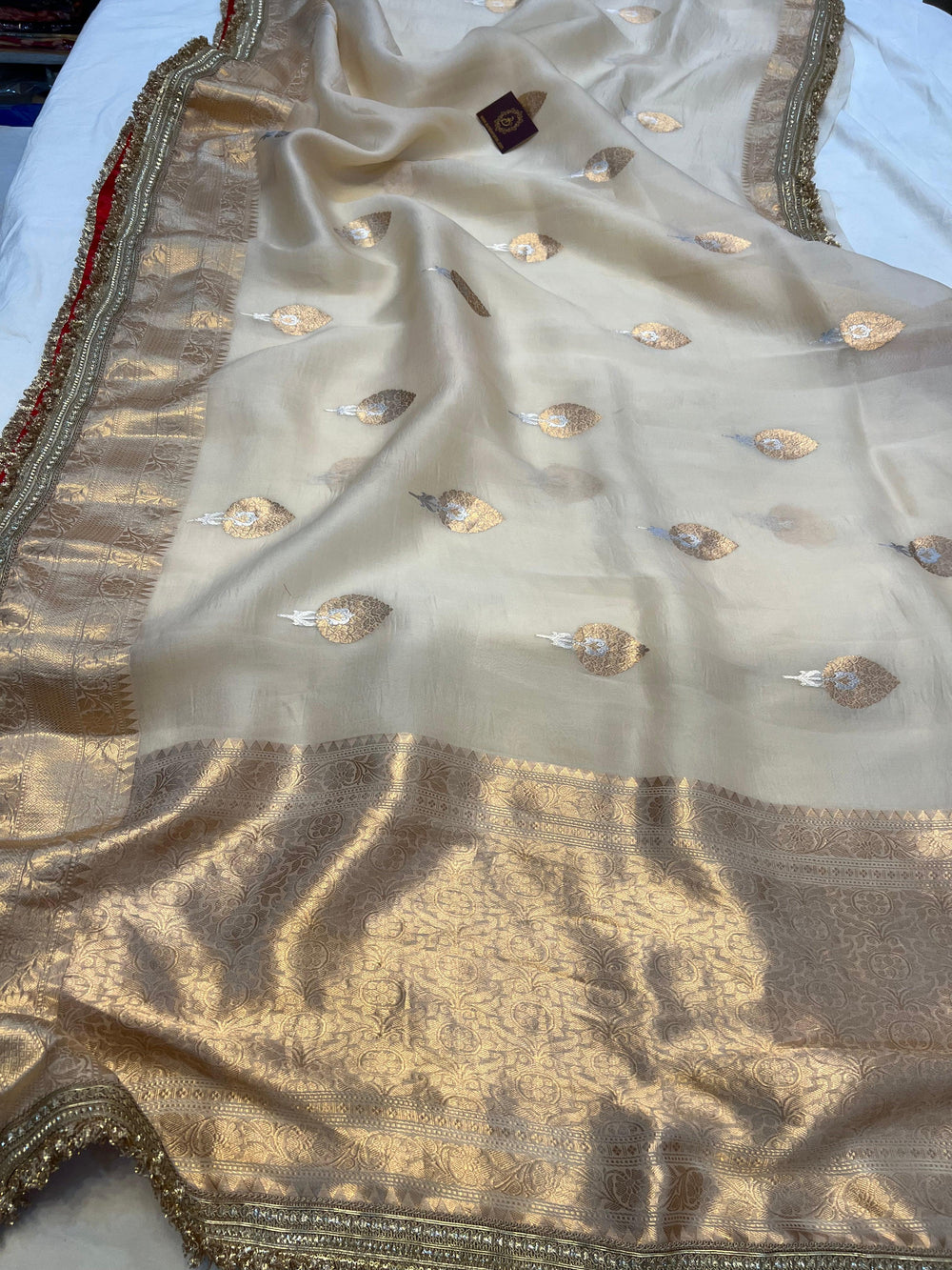 Front view of Pure Kora Silk Banarasi Saree draped on mannequin with golden zari border and Sona Rupa motifs