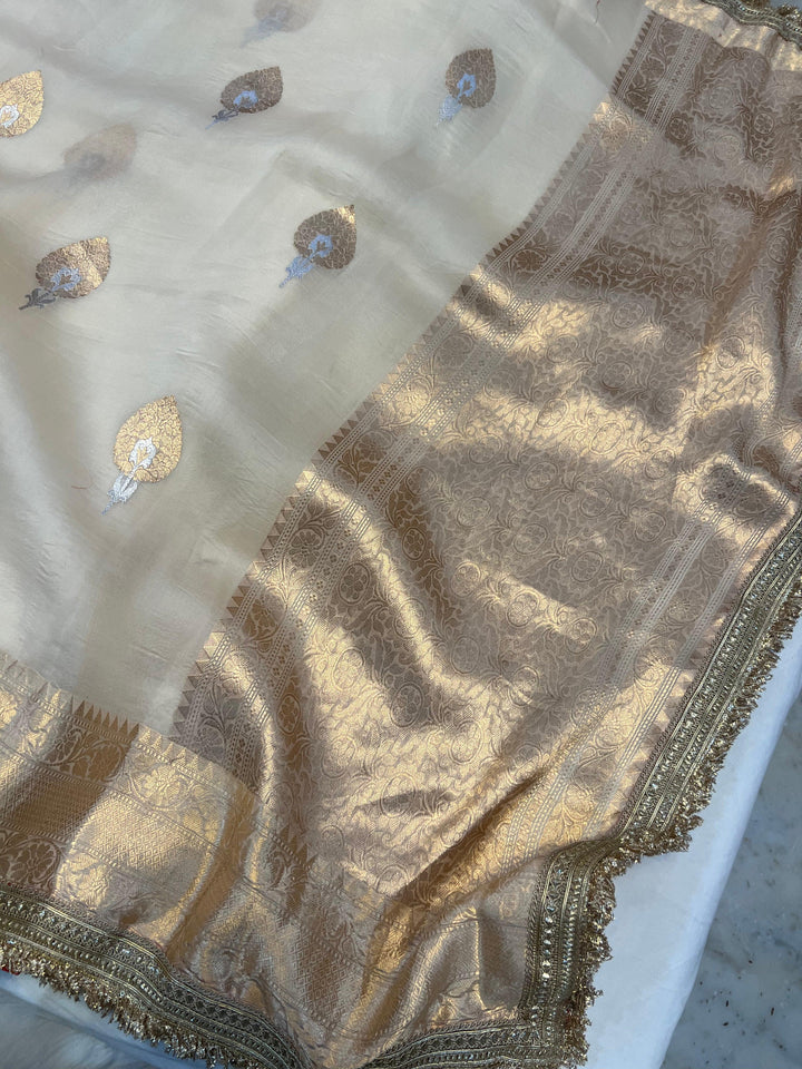Close-up of the golden zari pallu with intricate Kadhwa Sona Rupa weaving on Kora silk fabric