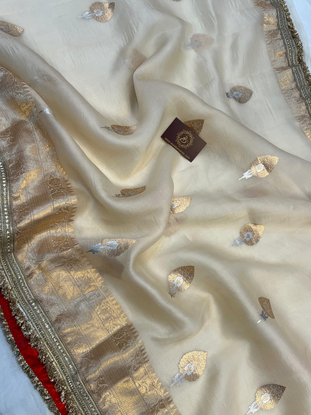 Detailed view of traditional Banarasi golden zari border on soft organza silk