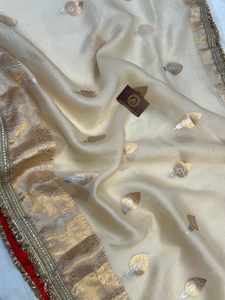 Detailed view of traditional Banarasi golden zari border on soft organza silk