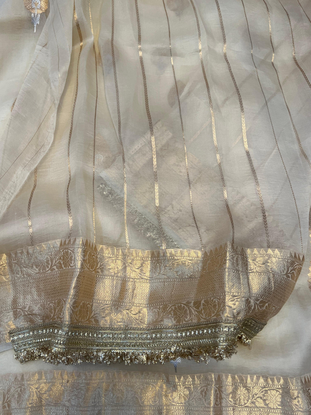 Unstitched striped blouse piece with zari border, paired with the Kora silk Banarasi saree