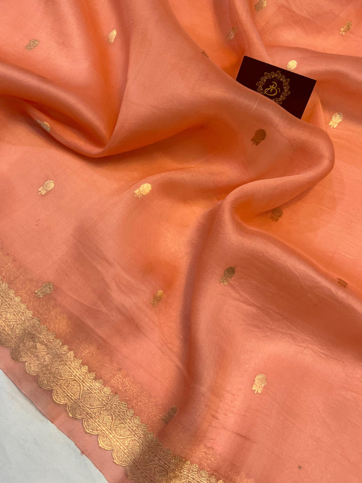 Detailed view of small golden zari butis on sheer Kora silk fabric, showcasing traditional Kadhwa weaving