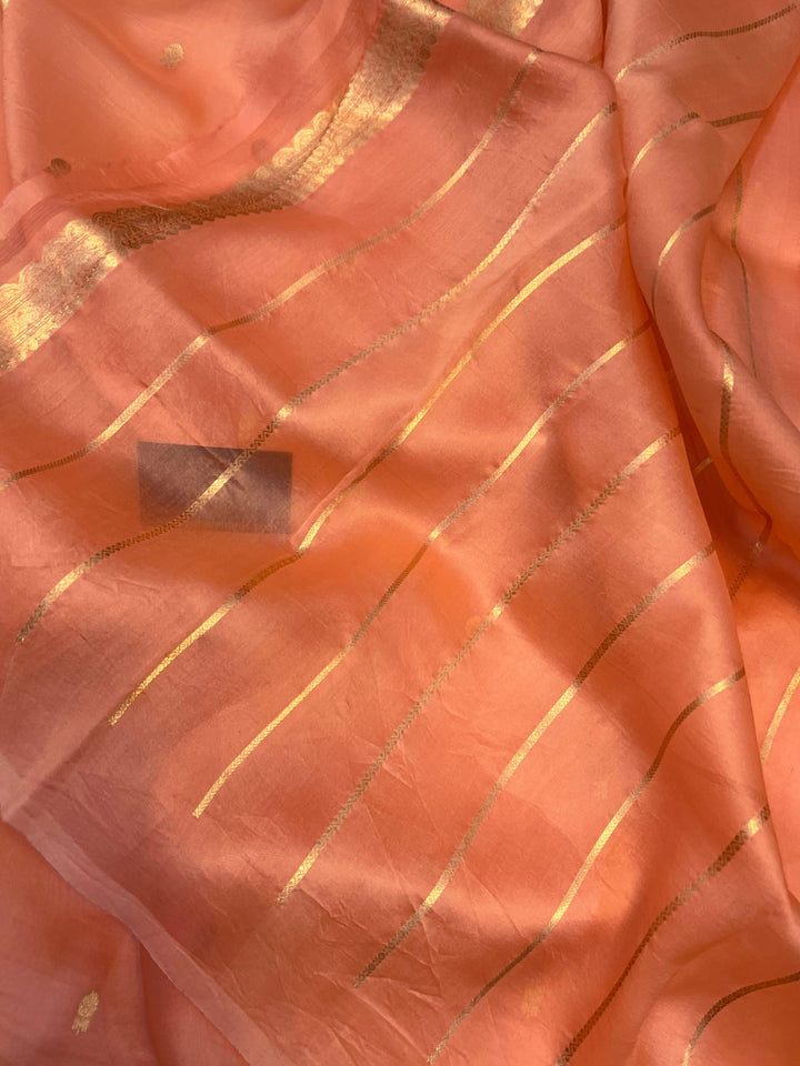 Stripe unstitched blouse piece paired with the handloom Banarasi Kora silk saree