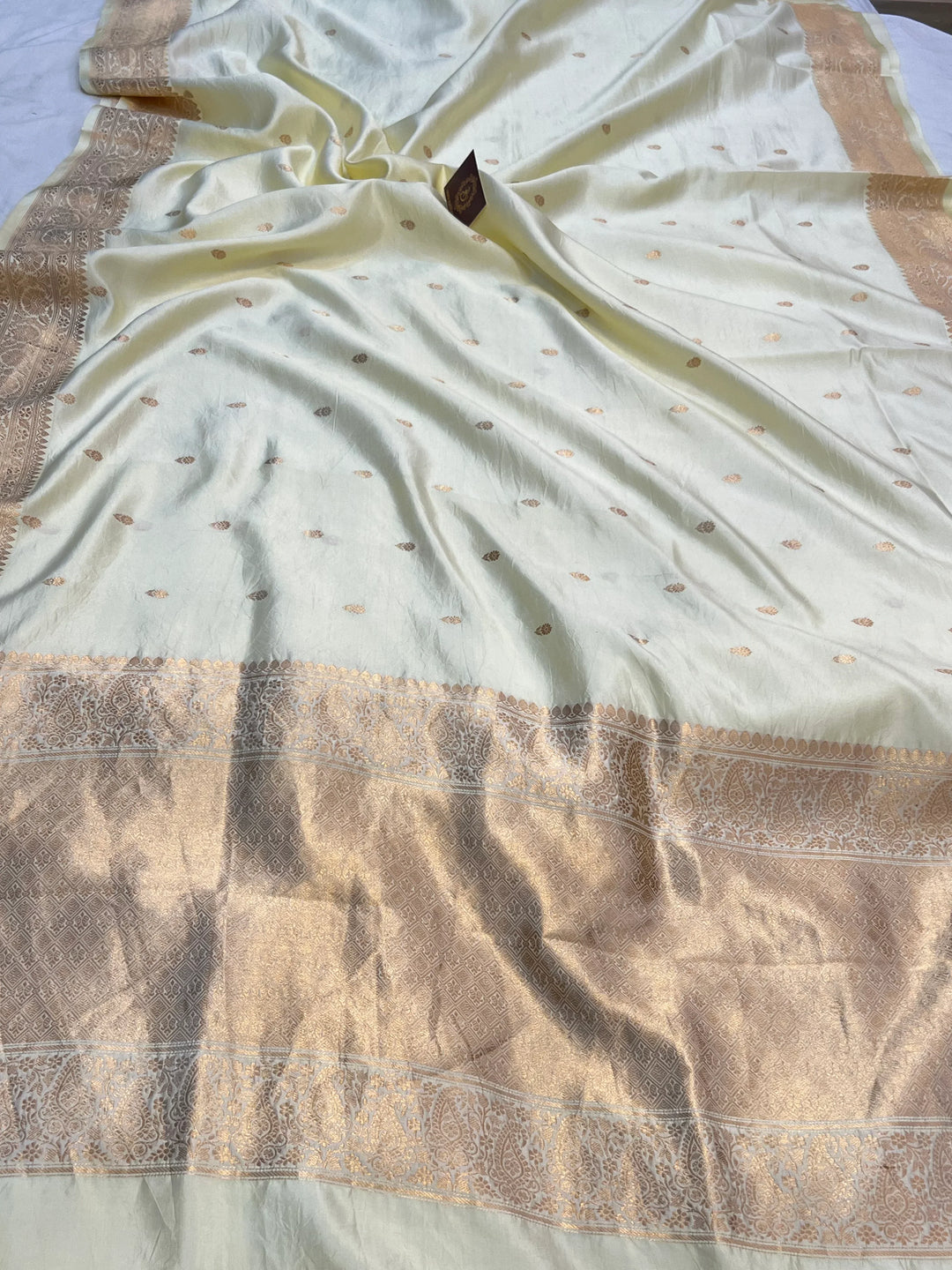 Pale Yellow Pure silk handloom Banarasi saree with Kadhwa butis, golden zari border, and striped blouse piece in rich traditional design