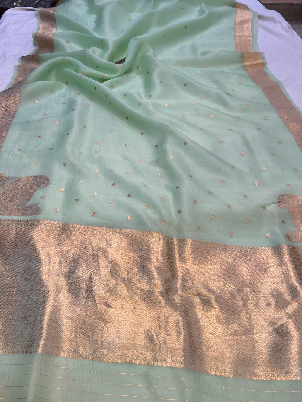 Pure Kora Silk Banarasi Saree draped with golden zari butis, sleek border, and woven Konia near the pallu