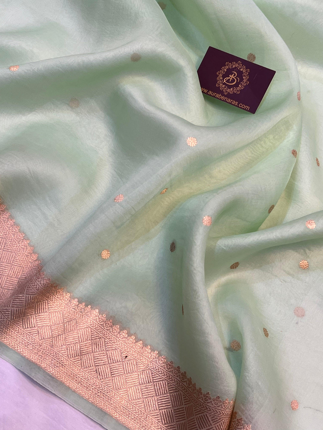 Small golden zari butis on handwoven Kora silk fabric using traditional Kadhwa technique