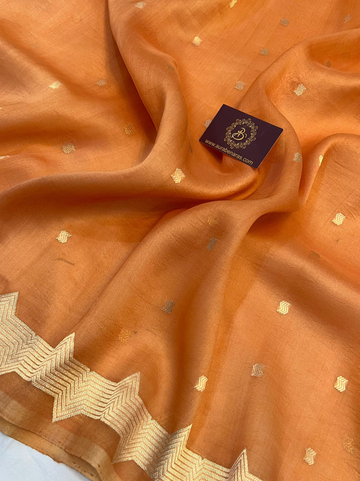 Detailed view of small golden zari butis on sheer Kora silk fabric, showcasing traditional Kadhwa weaving