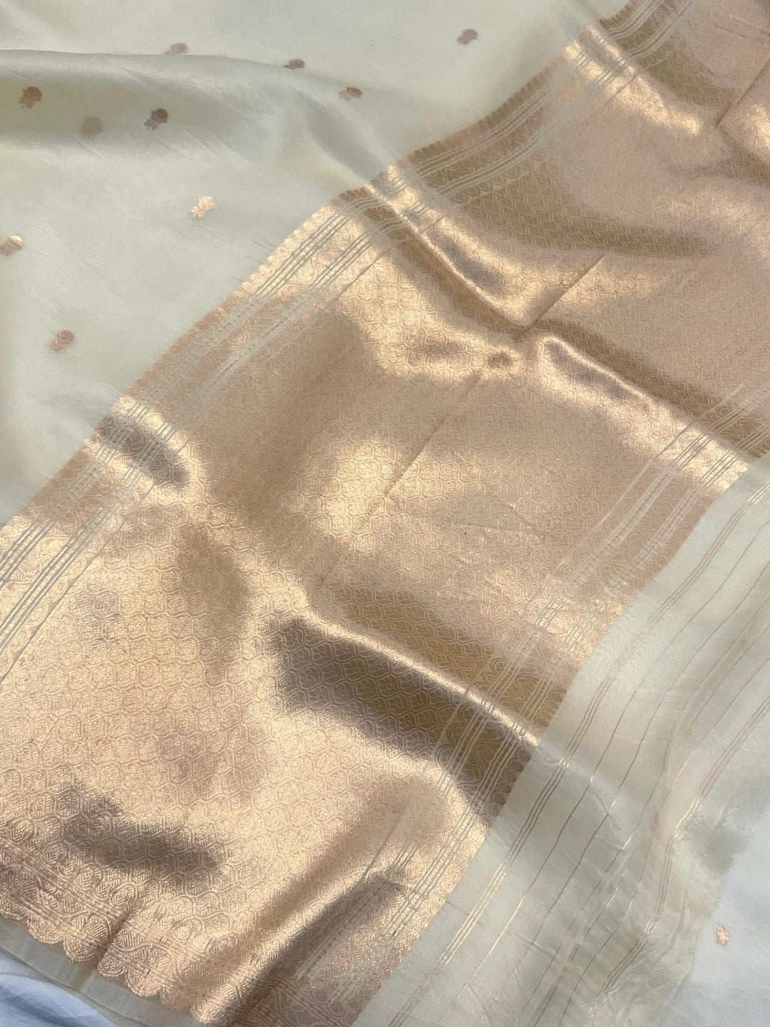 Elegant pallu of pure Kora silk Banarasi saree with subtle golden zari detailing