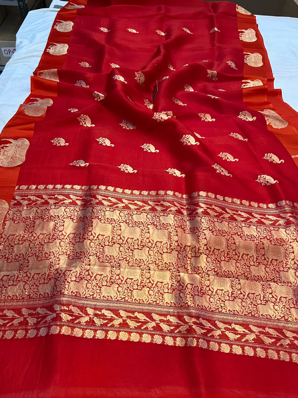 Reddish Orange Kora Silk Banarasi Saree | Cow Motif Border
