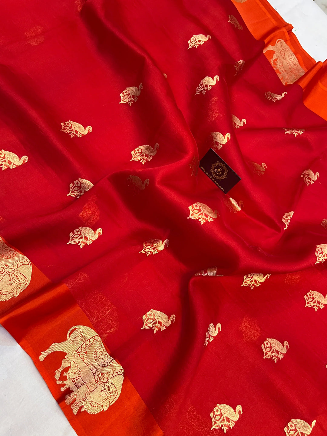 Reddish Orange Kora Silk Banarasi Saree | Cow Motif Border