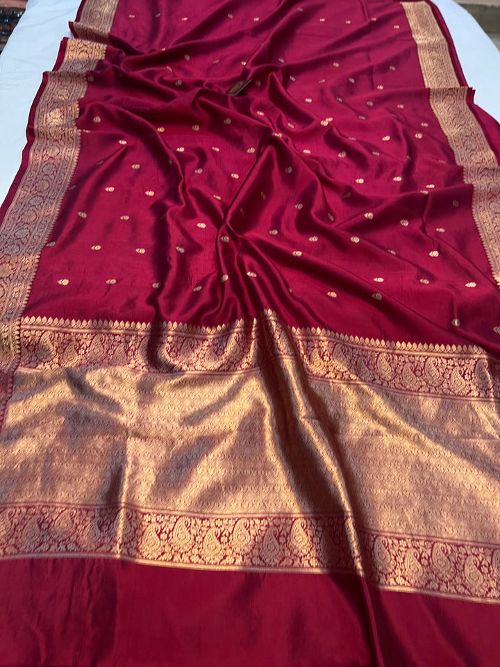 Maroon pure silk handloom Banarasi saree with Kadhwa butis, golden zari border, and striped blouse piece in rich traditional design