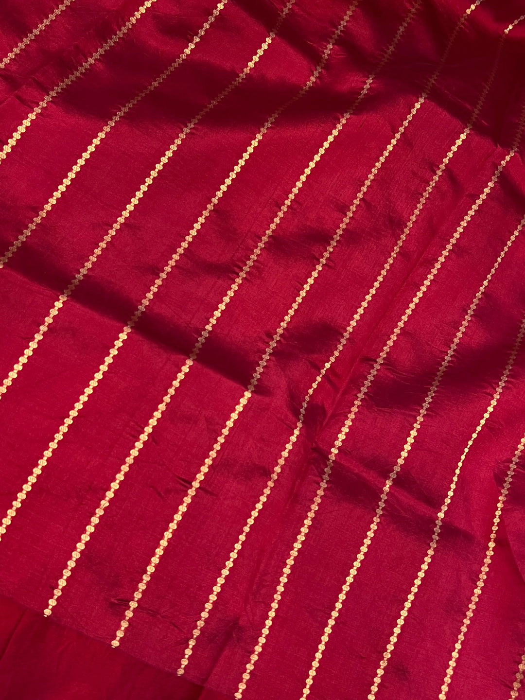 Maroon pure silk handloom Banarasi saree with Kadhwa butis, golden zari border, and striped blouse piece in rich traditional design