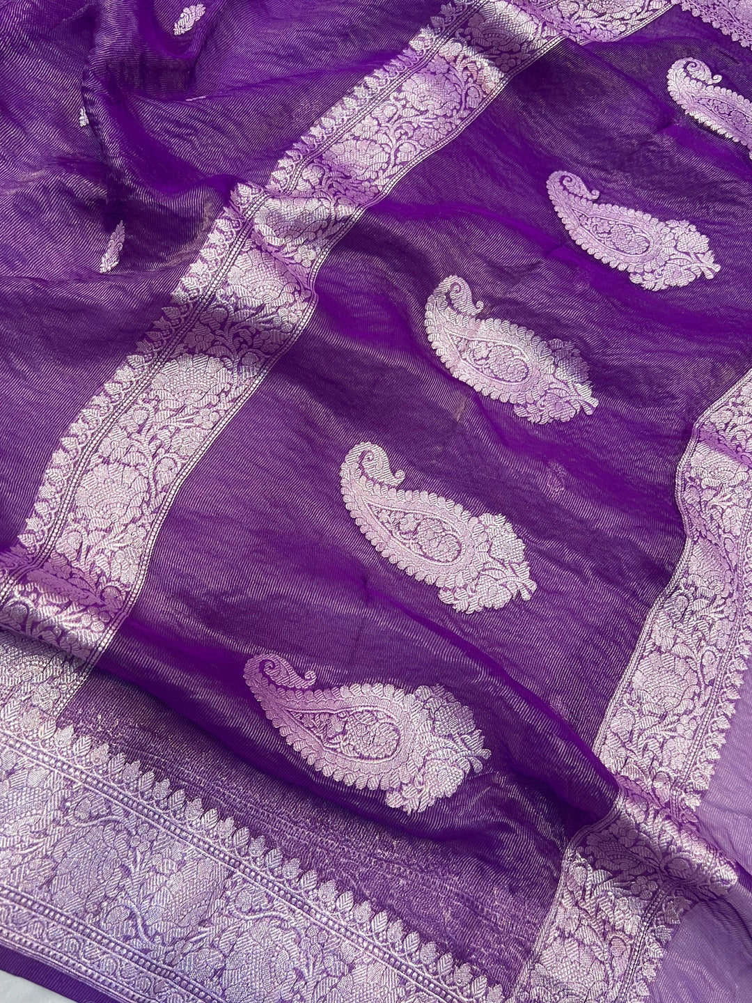 Silver zari Kadhwa border and handwoven butis on Banarasi tissue silk saree