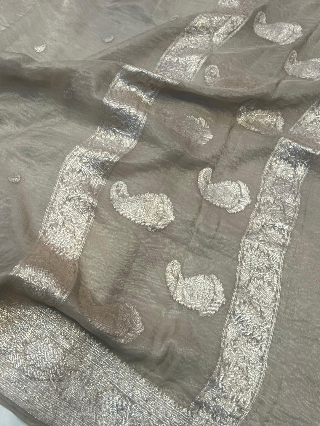 Silver zari Kadhwa border and handwoven butis on Banarasi tissue silk saree