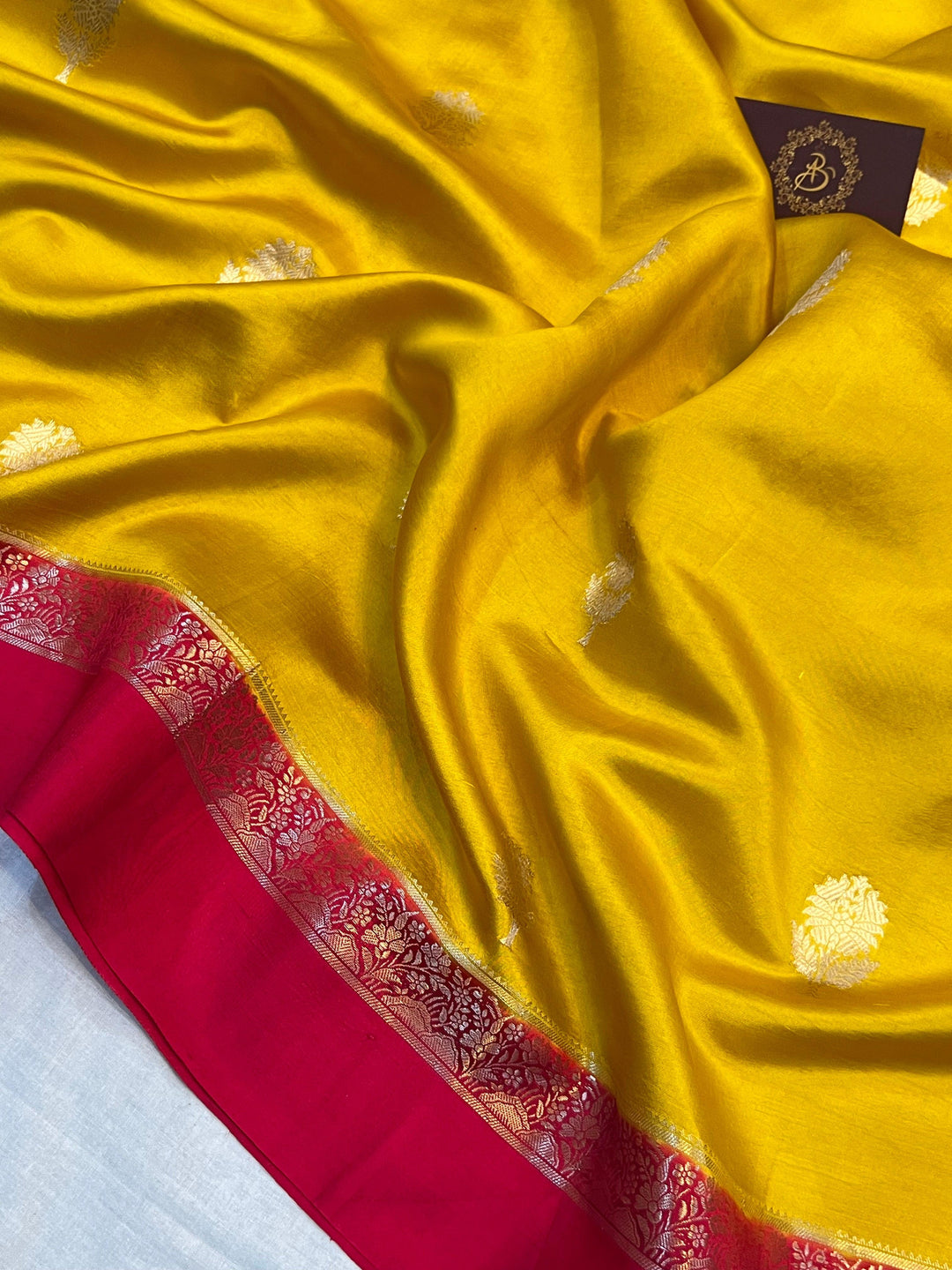 Intricate golden zari Kadhwa butas on pure silk Banarasi saree