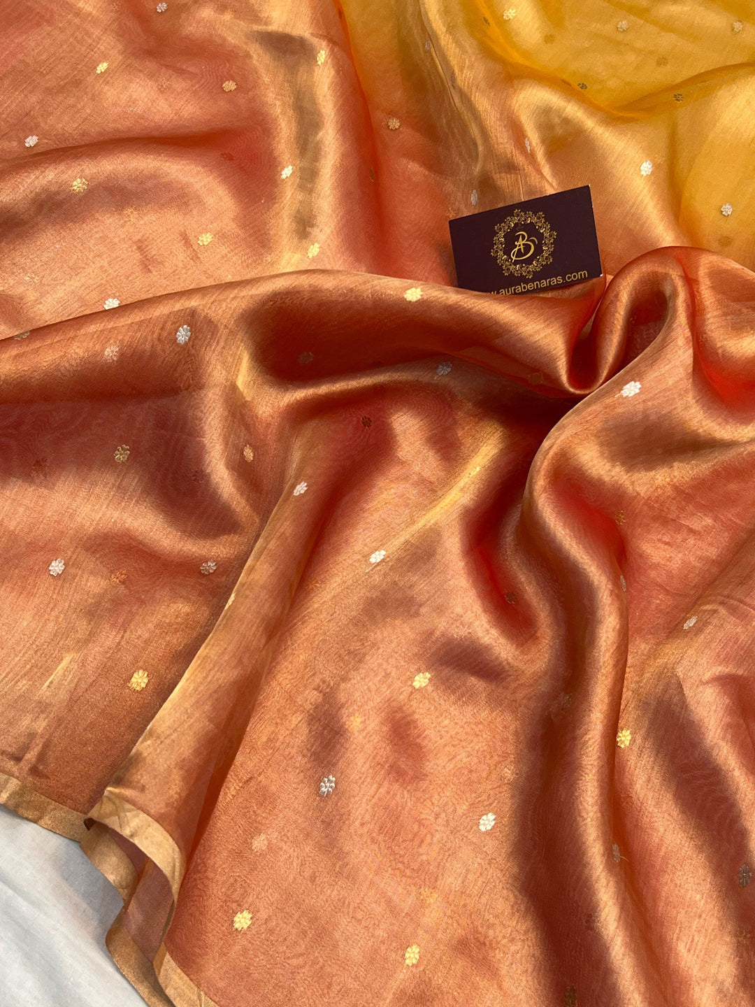 Intricate gold and silver Kadhwa butis on shaded tissue silk Banarasi saree