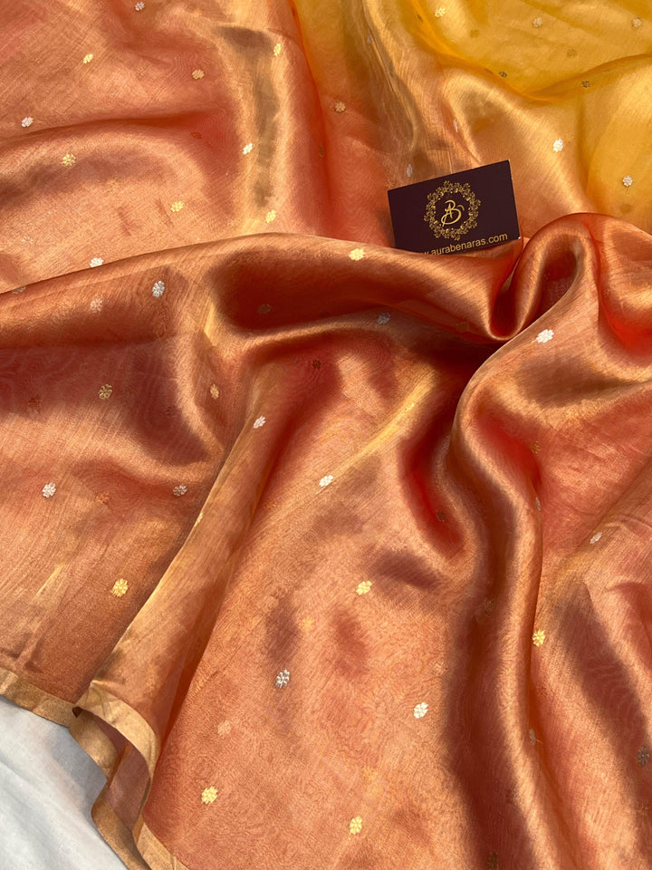 Intricate gold and silver Kadhwa butis on shaded tissue silk Banarasi saree
