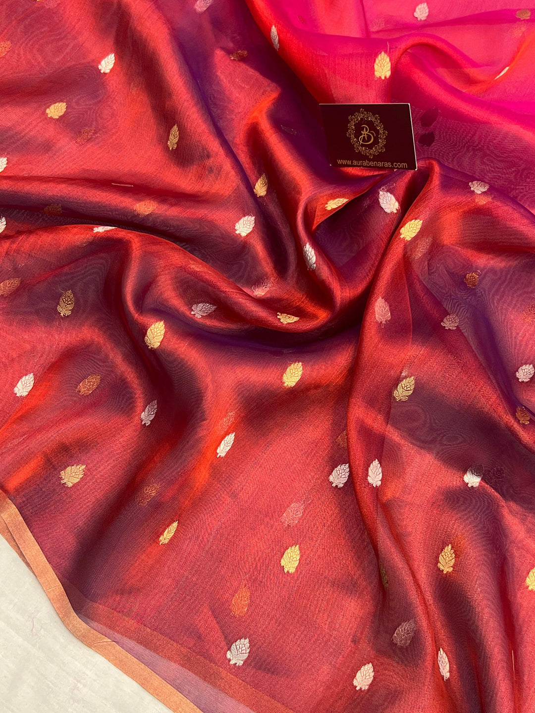 Intricate gold and silver Kadhwa butis on shaded tissue silk Banarasi saree