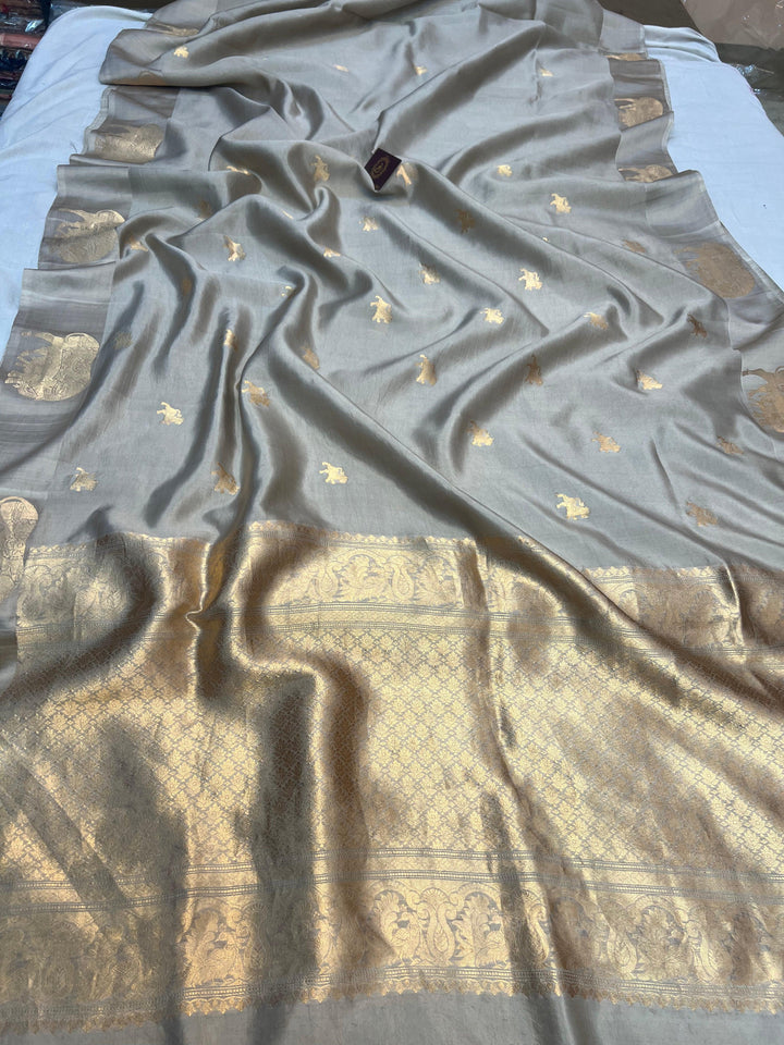 Pure silk handloom Banarasi saree with golden zari Kadhwa motifs and Mashru silk border featuring animal designs
