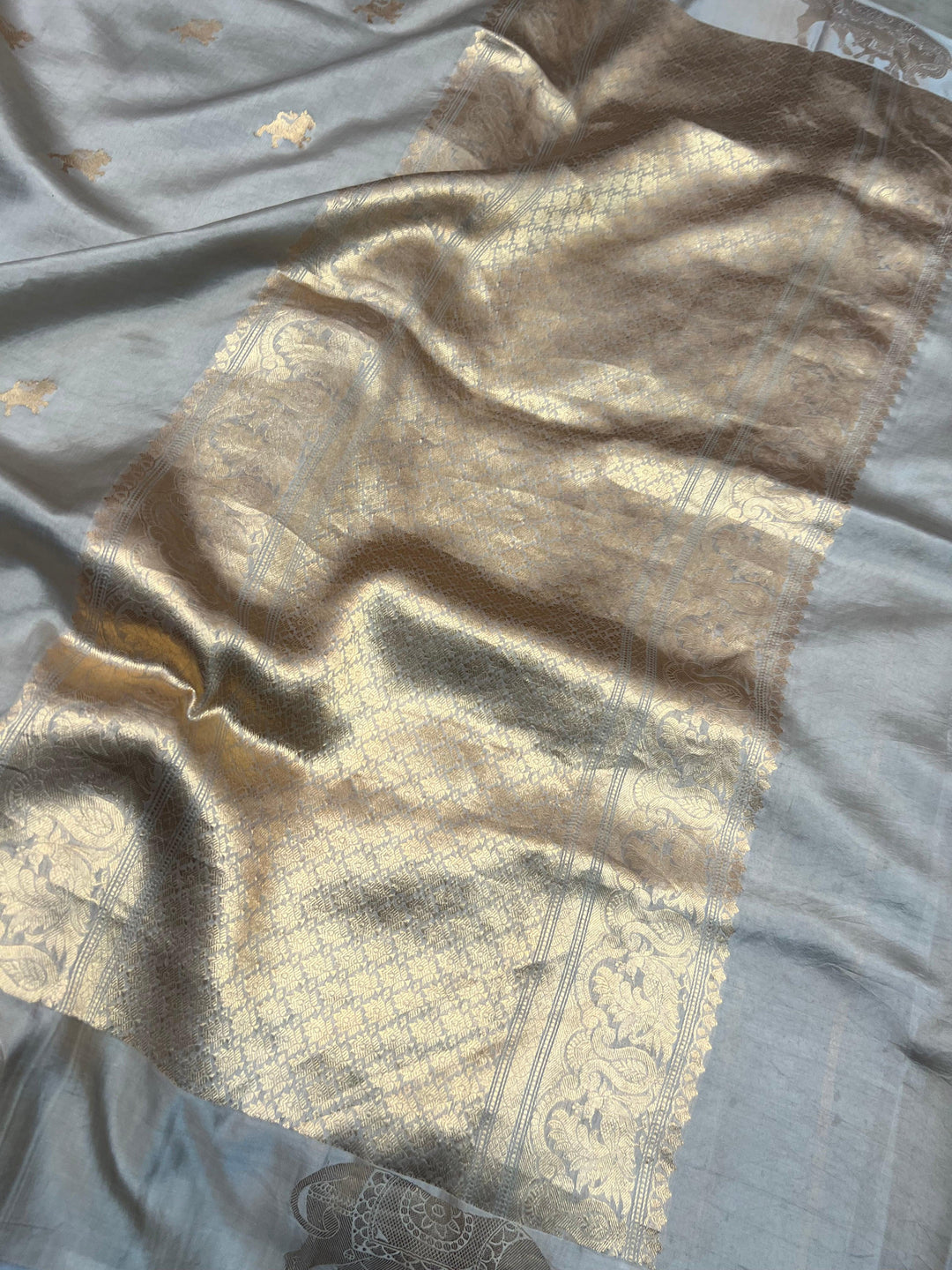 Close-up of Mashru silk border with intricate Kadhwa animal motifs on Banarasi saree