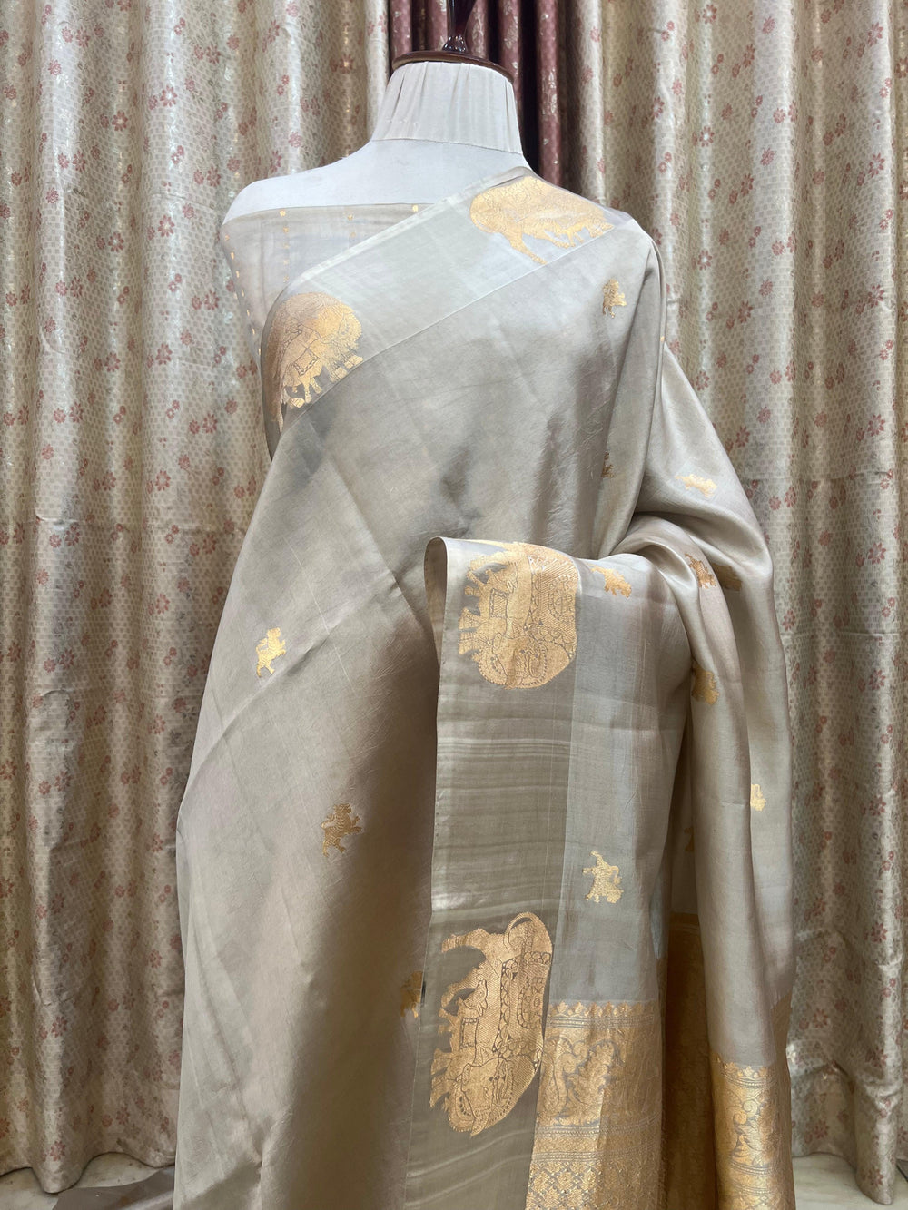 Pure silk handloom Banarasi saree with golden zari Kadhwa motifs and Mashru silk border featuring animal designs