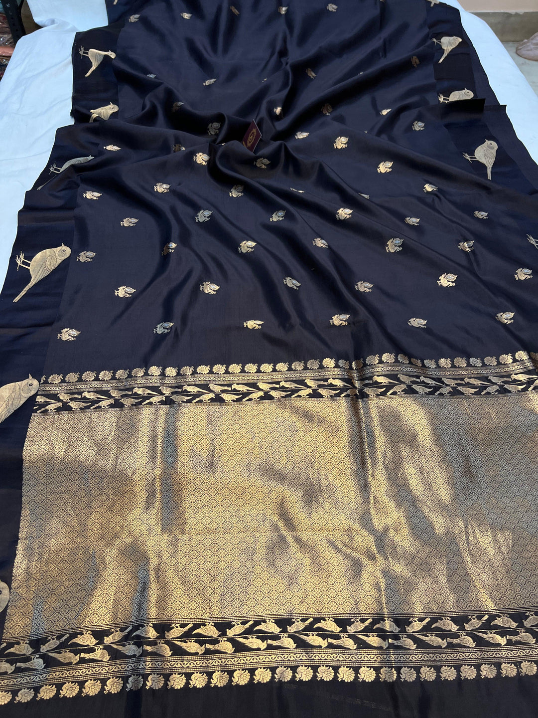 Pure silk handloom Banarasi saree with golden zari Kadhwa motifs and Mashru silk border featuring animal designs