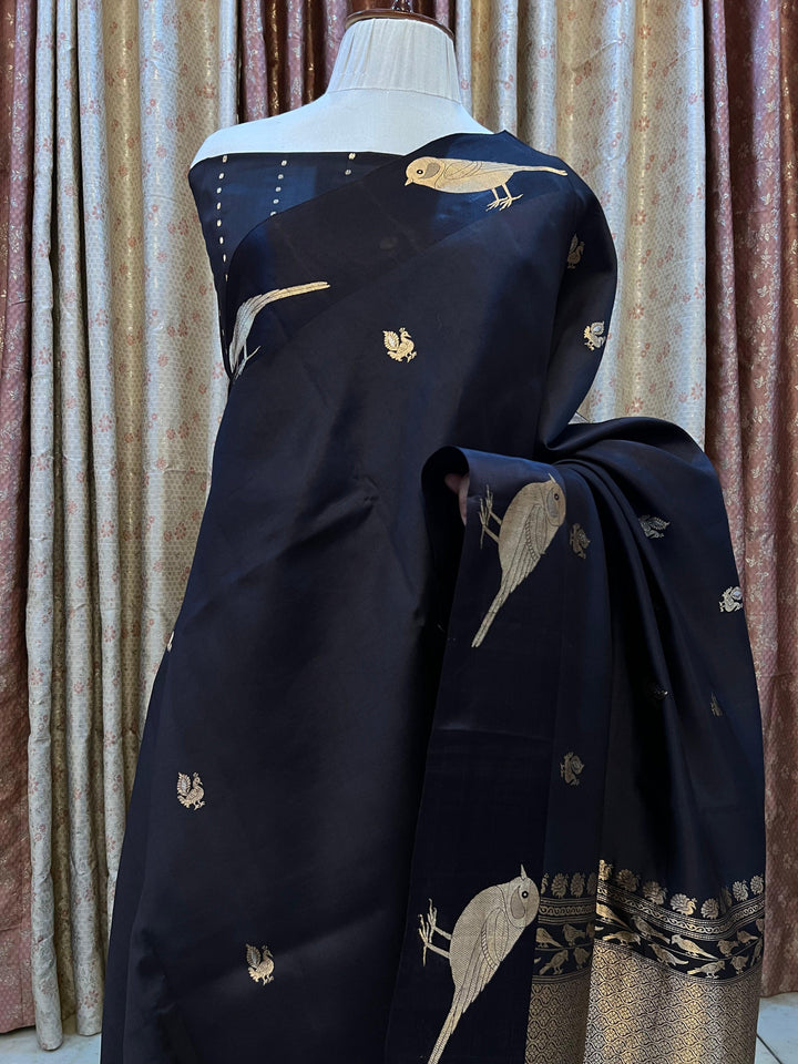 Pure silk handloom Banarasi saree with golden zari Kadhwa motifs and Mashru silk border featuring animal designs