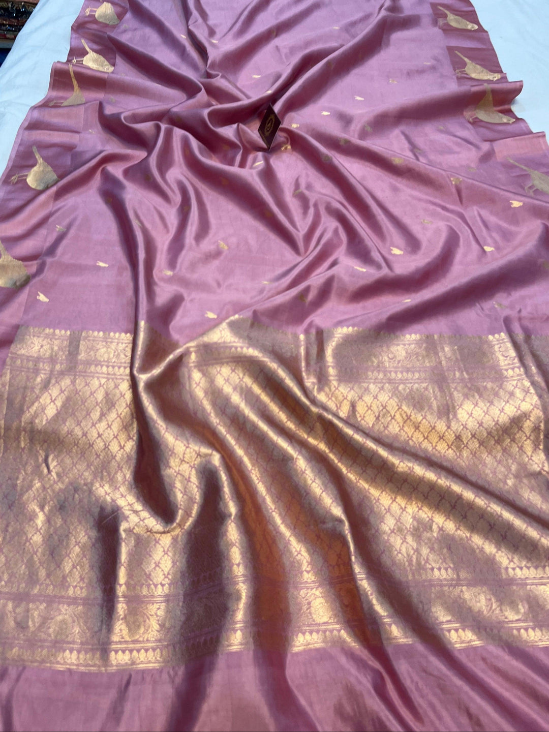 Pure silk handloom Banarasi saree with golden zari Kadhwa motifs and Mashru silk border featuring animal designs