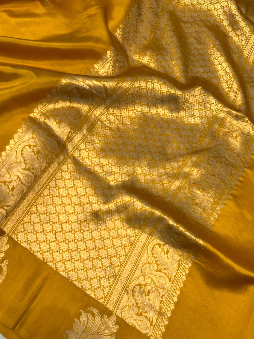 Close-up of Mashru silk border with intricate Kadhwa animal motifs on Banarasi saree