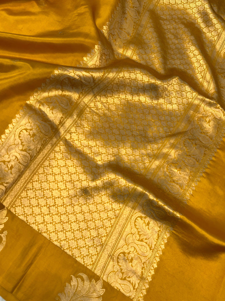 Close-up of Mashru silk border with intricate Kadhwa animal motifs on Banarasi saree