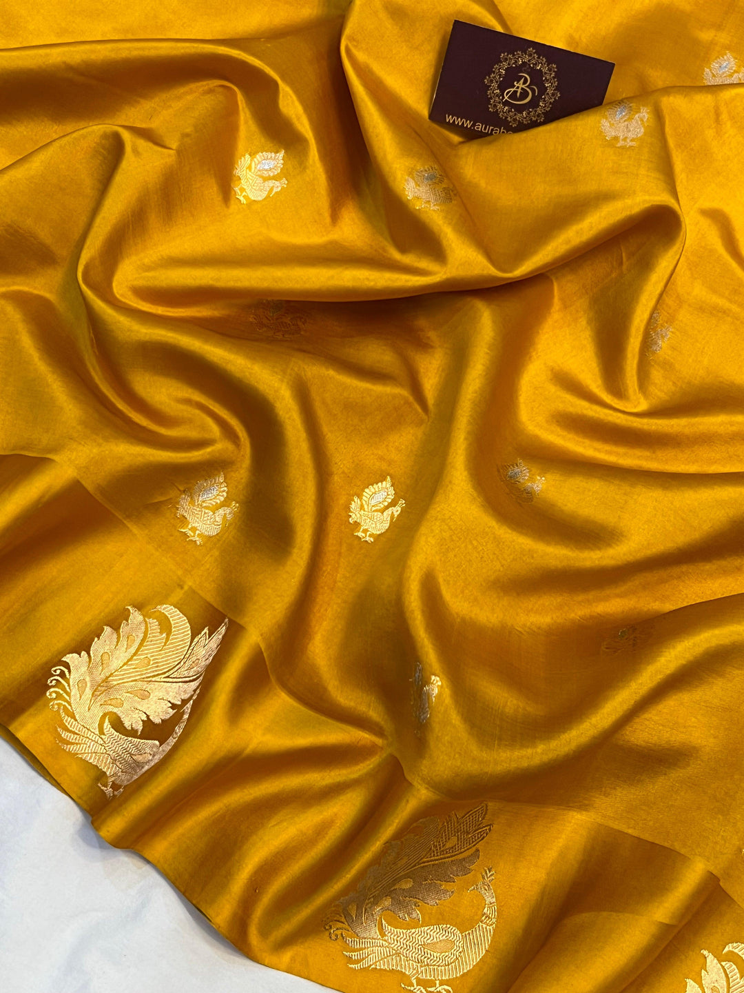 Detailed view of golden zari Kadhwa motifs on pure silk Banarasi saree