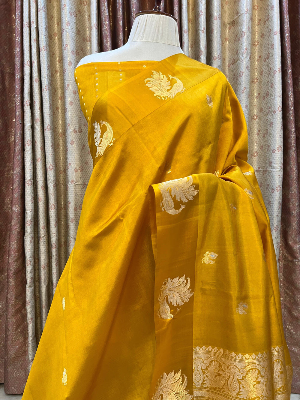 Pure silk handloom Banarasi saree with golden zari Kadhwa motifs and Mashru silk border featuring animal designs