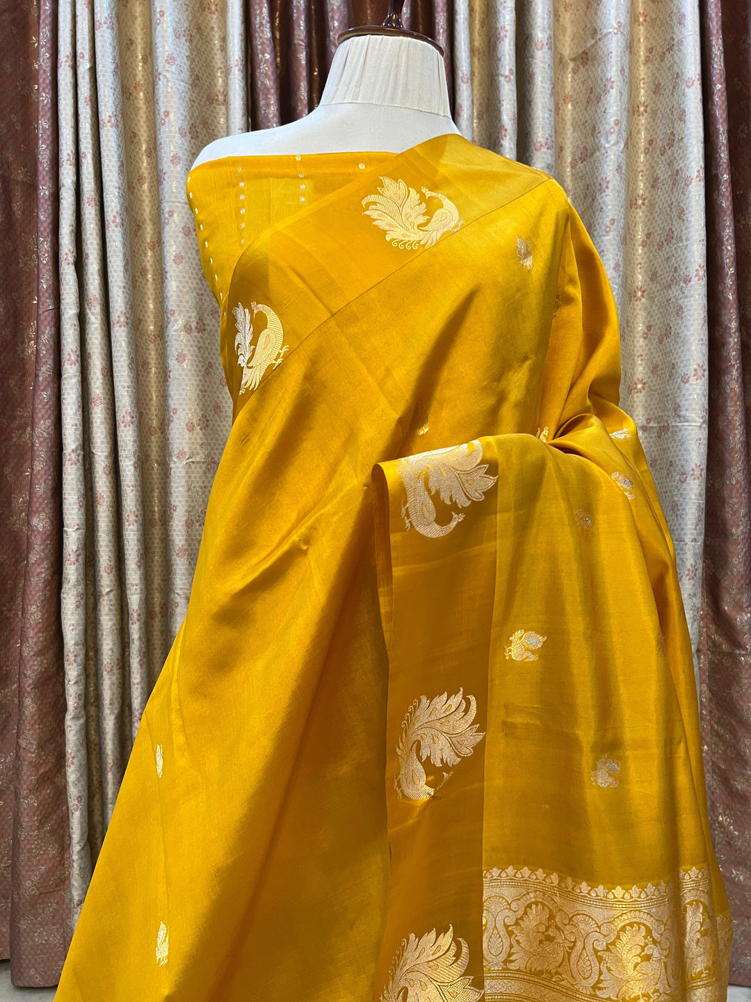 Pure silk handloom Banarasi saree with golden zari Kadhwa motifs and Mashru silk border featuring animal designs