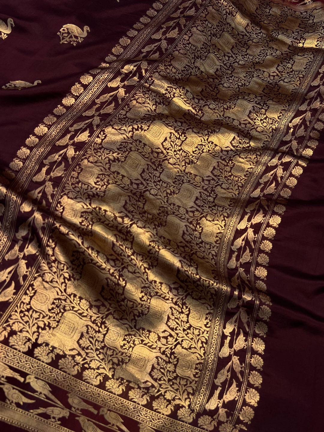 Close-up of Mashru silk border with intricate Kadhwa animal motifs on Banarasi saree