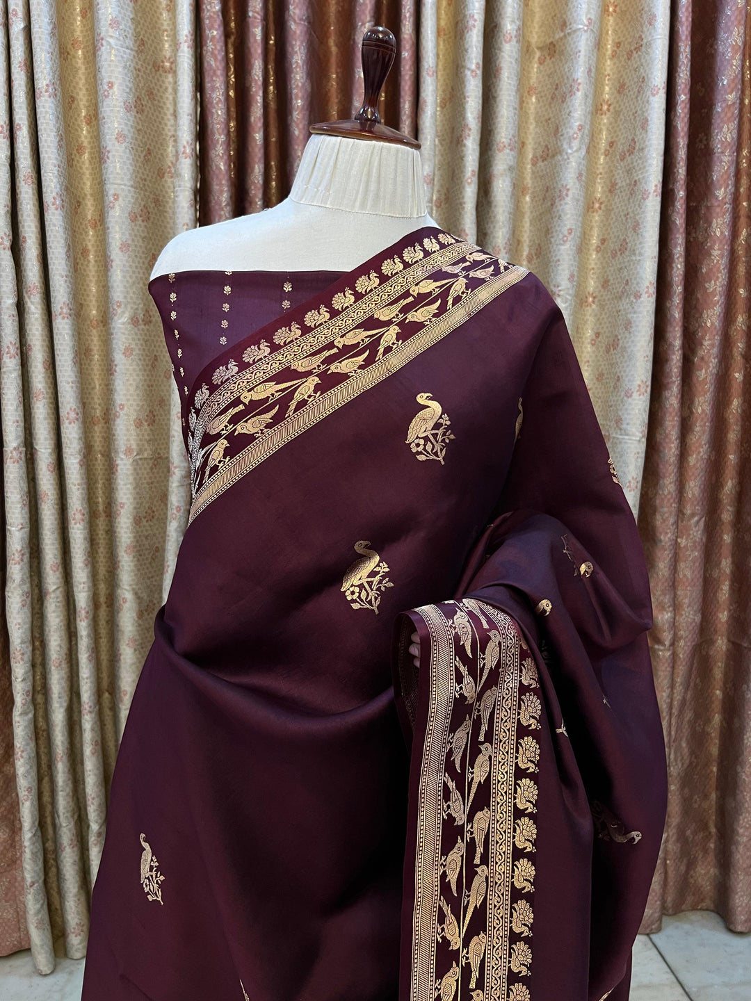 Pure silk handloom Banarasi saree with golden zari Kadhwa motifs and Mashru silk border featuring animal designs