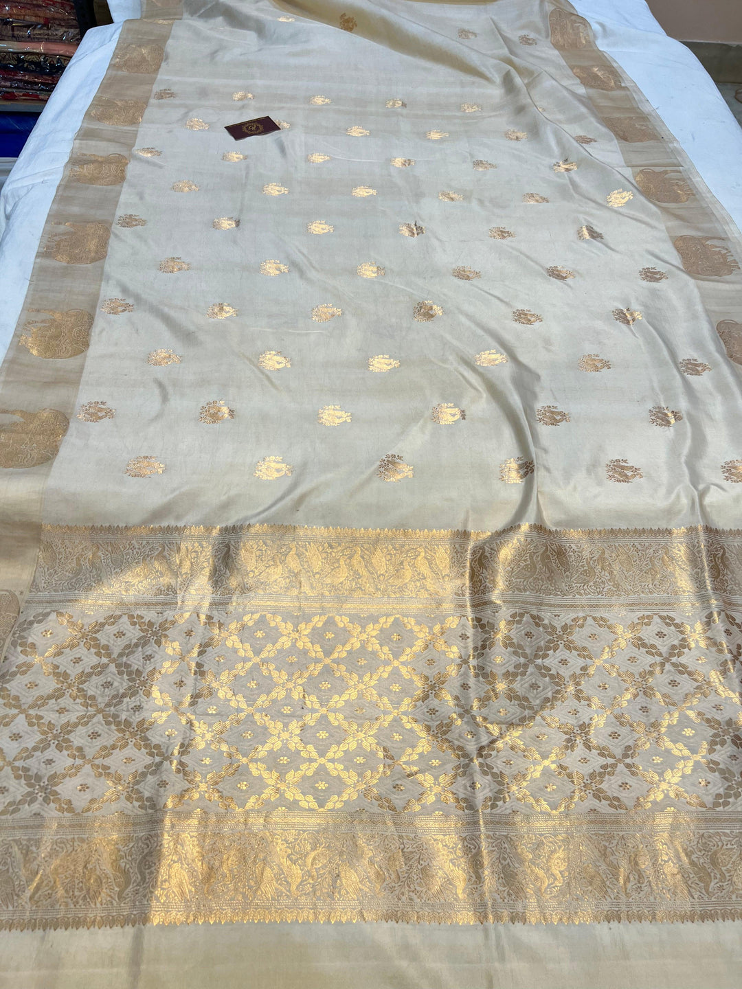 Pure silk handloom Banarasi saree with golden zari Kadhwa motifs and Mashru silk border featuring animal designs