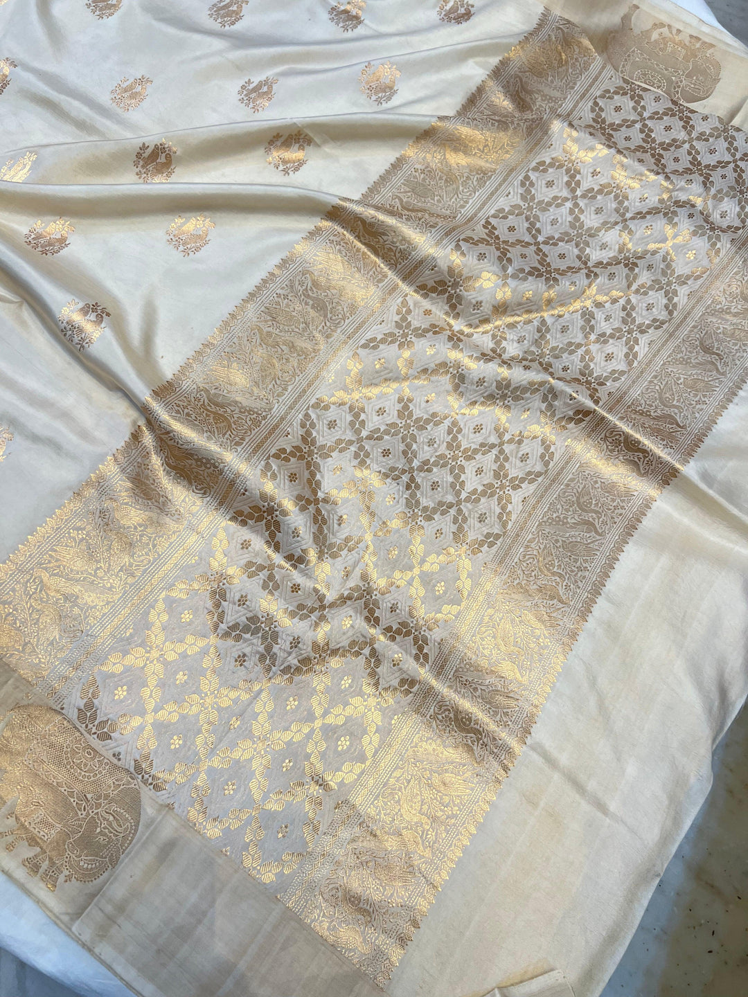 Close-up of Mashru silk border with intricate Kadhwa animal motifs on Banarasi saree