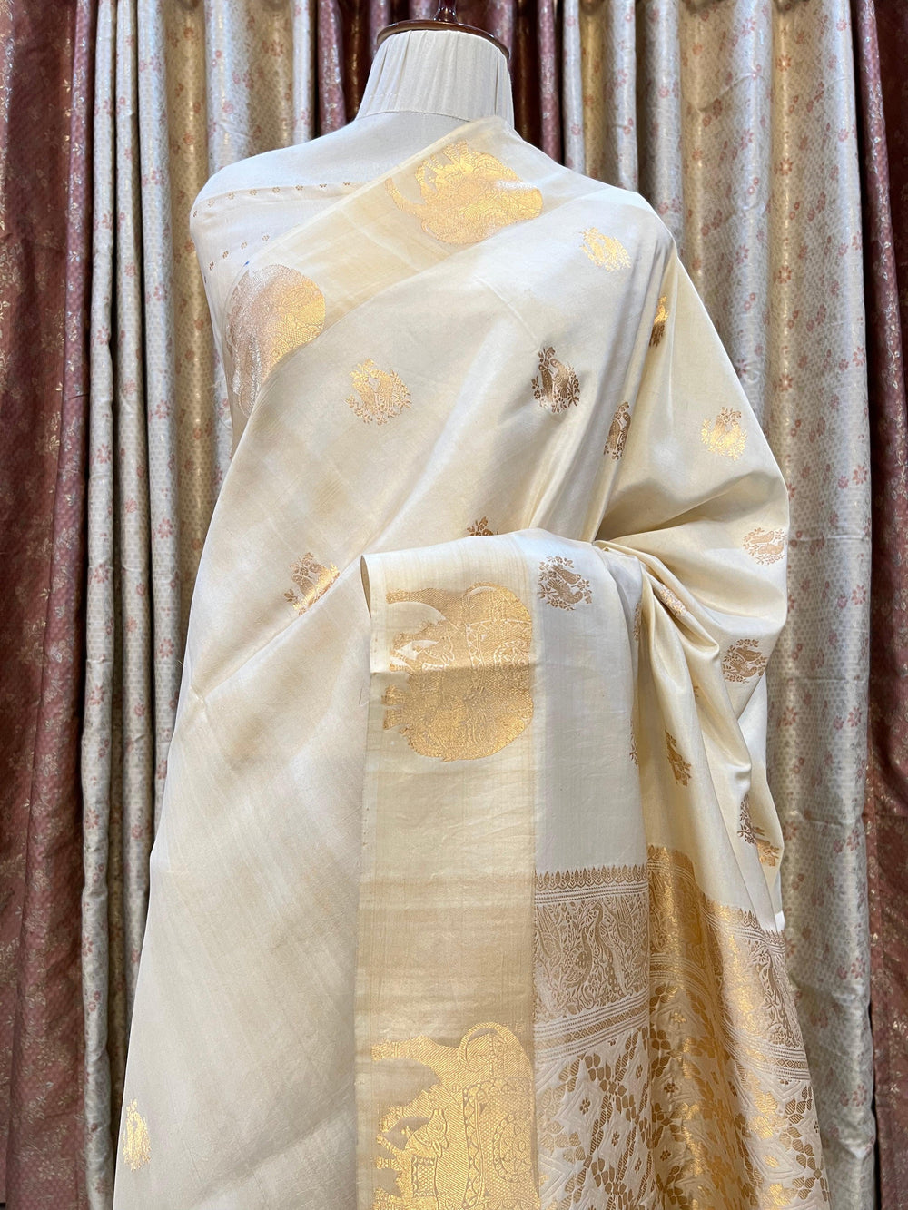 Pure silk handloom Banarasi saree with golden zari Kadhwa motifs and Mashru silk border featuring animal designs