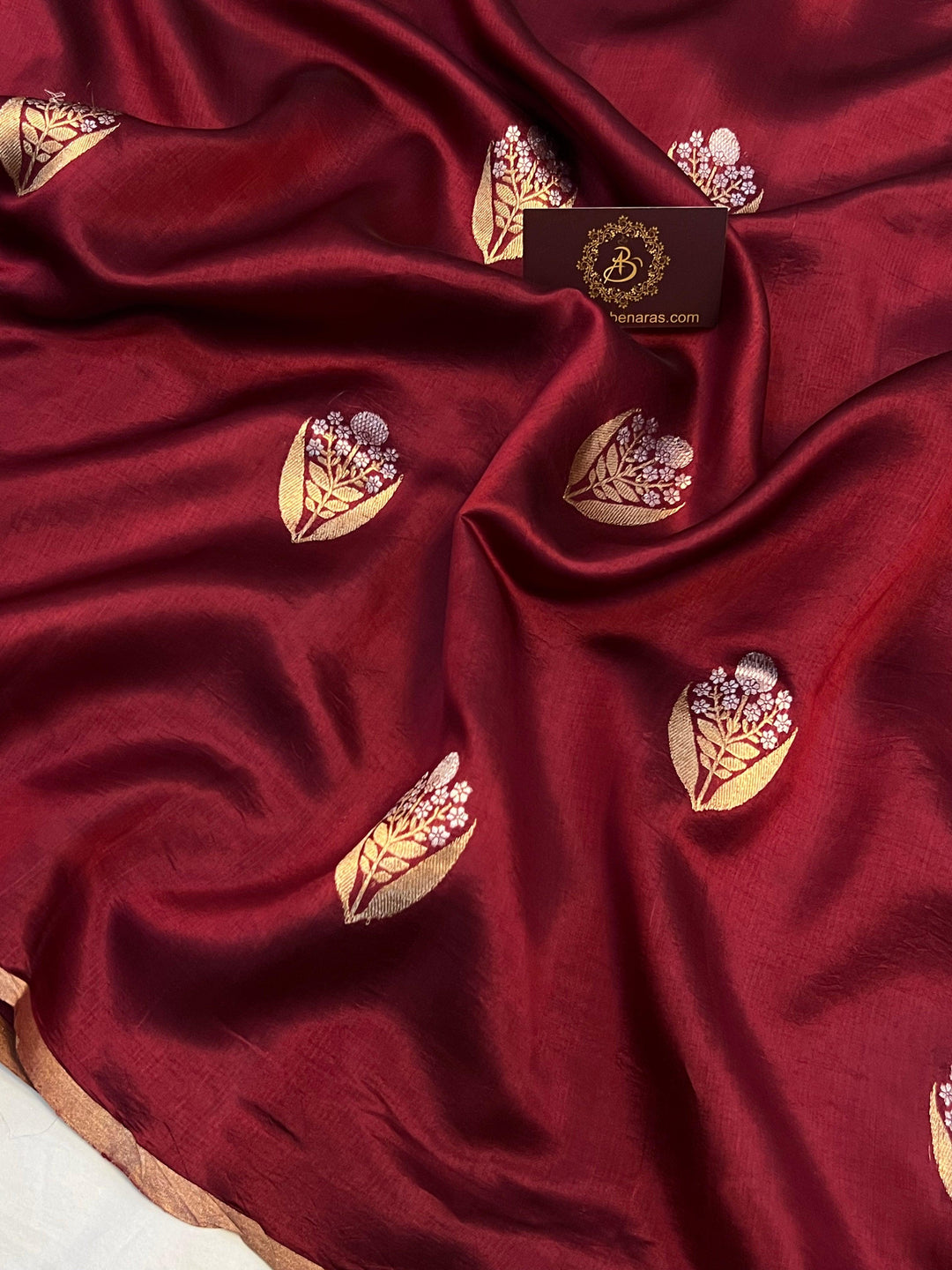 Detailed view of gold and silver Kadhwa Sona Rupa motifs on pure silk Banarasi saree.