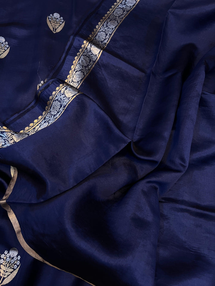 Plain blouse piece with matching border included with pure silk Banarasi saree.