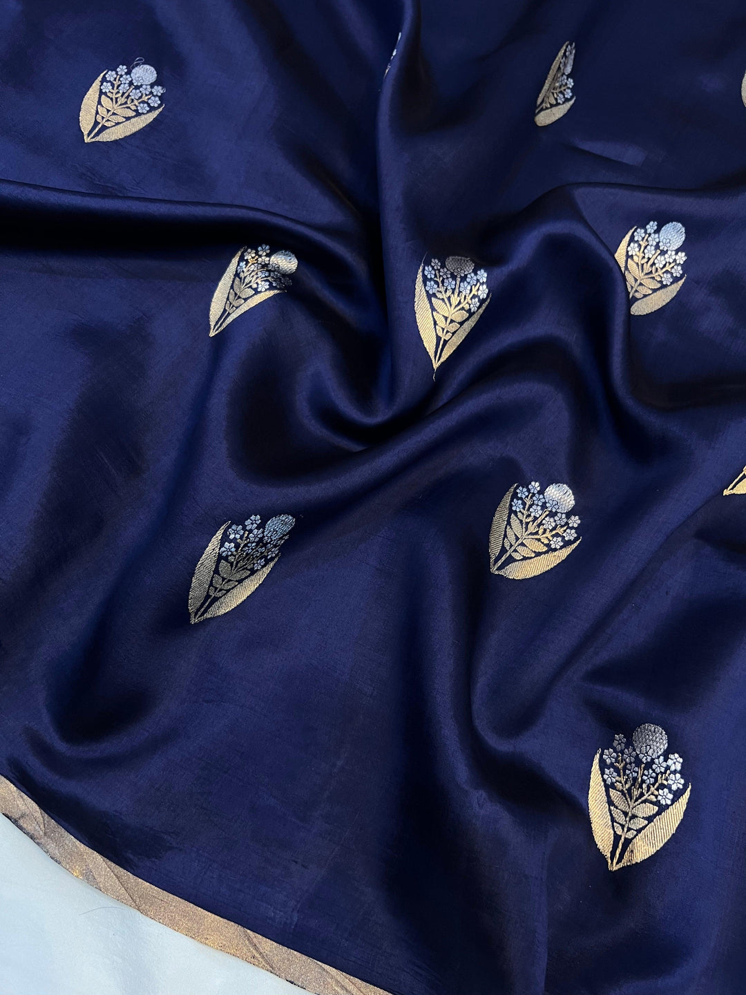 Detailed view of gold and silver Kadhwa Sona Rupa motifs on pure silk Banarasi saree.