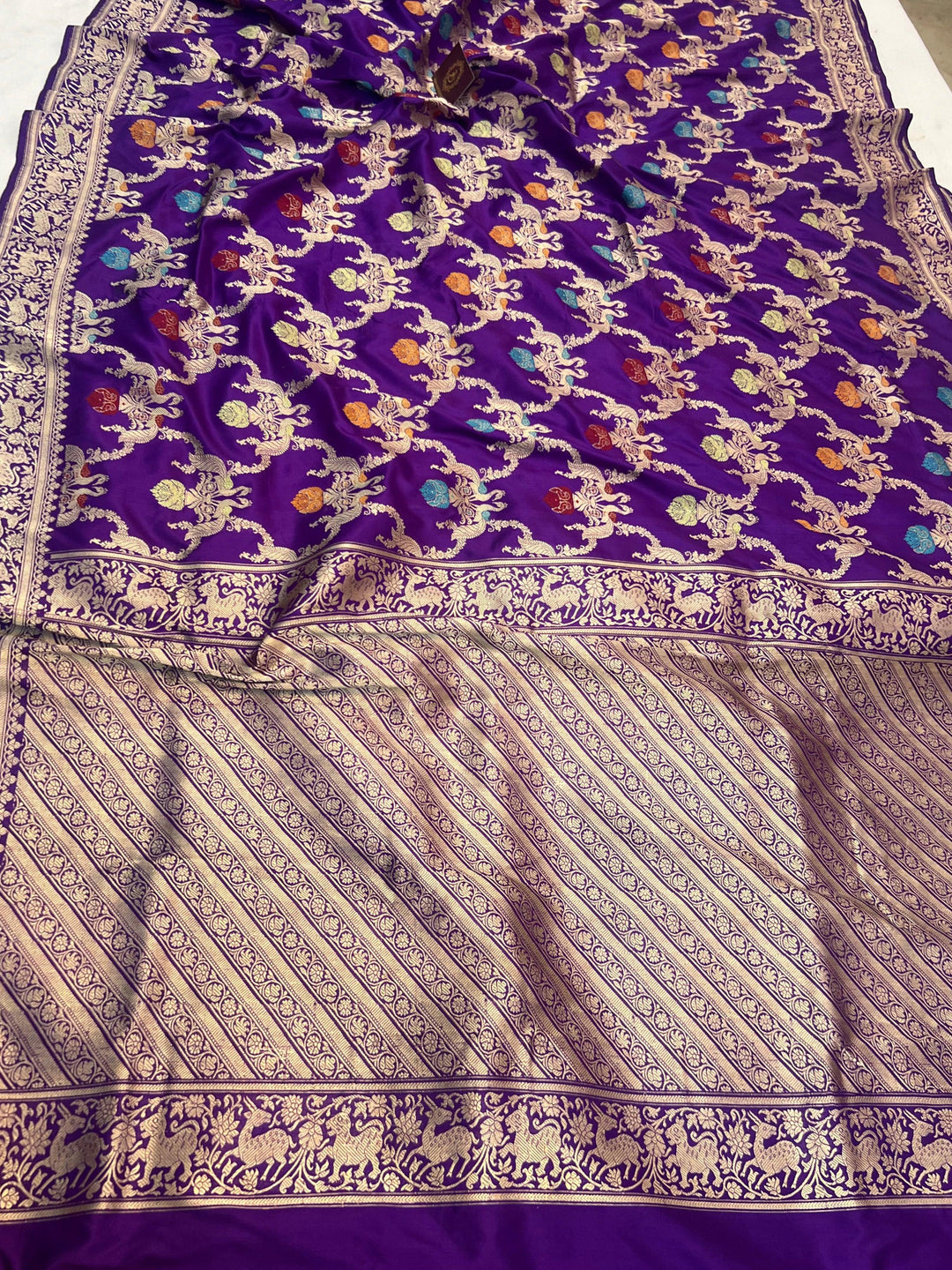 Pure Banarasi handloom Katan silk saree draped with intricate Kadhwa Meenakari Shikargah Jaal design, featuring hunting scenes and lush nature motifs