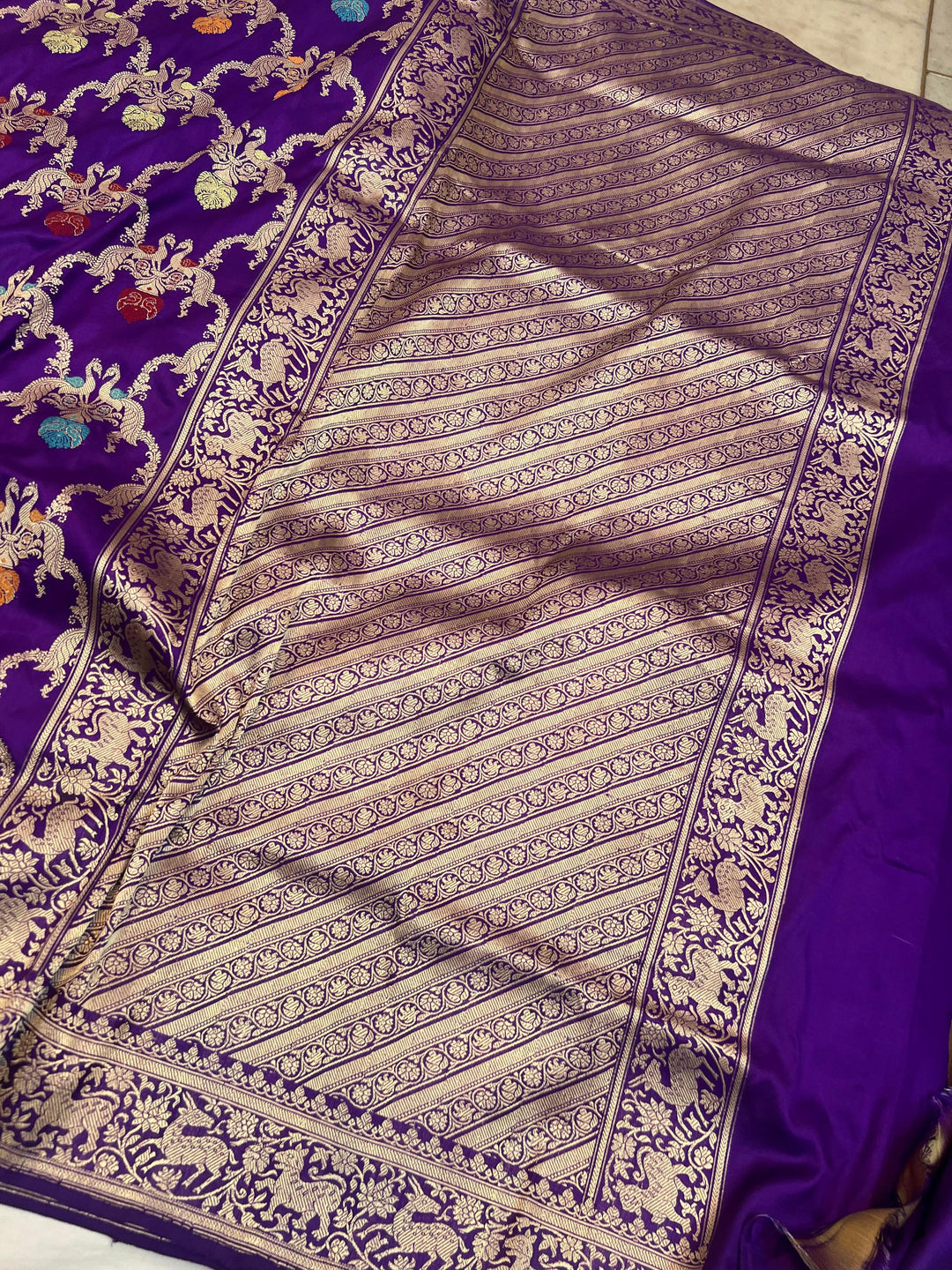 Elegant pallu of pure Banarasi handloom Katan silk saree showcasing Shikargah hunting scene motifs with colorful Meenakari accents
