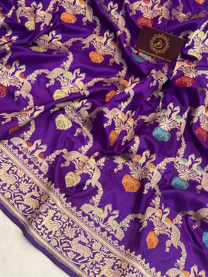 Close-up of detailed Kadhwa Meenakari Shikargah jaal weaving with motifs of birds, animals, and nature elements on pure Katan silk Banarasi saree