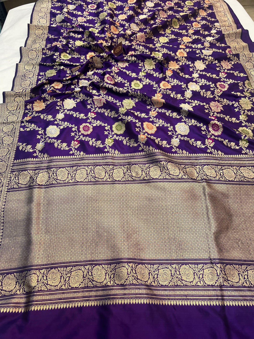 Pure Banarasi handloom Katan silk saree draped with intricate Kadhwa jaal patterns and Meenakari work in rich floral designs
