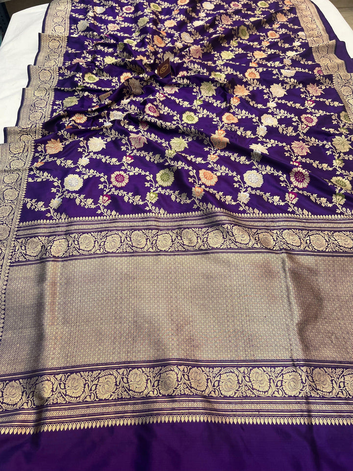 Pure Banarasi handloom Katan silk saree draped with intricate Kadhwa jaal patterns and Meenakari work in rich floral designs