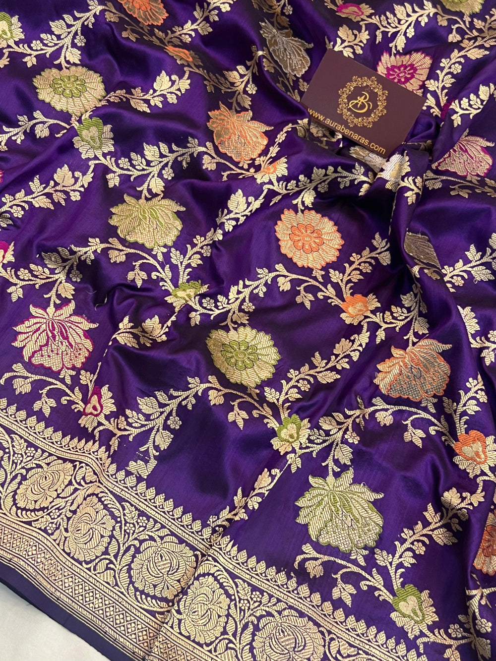 Close-up of detailed Kadhwa jaal weaving with floral motifs and vibrant Meenakari-inspired accents on pure Katan silk Banarasi saree