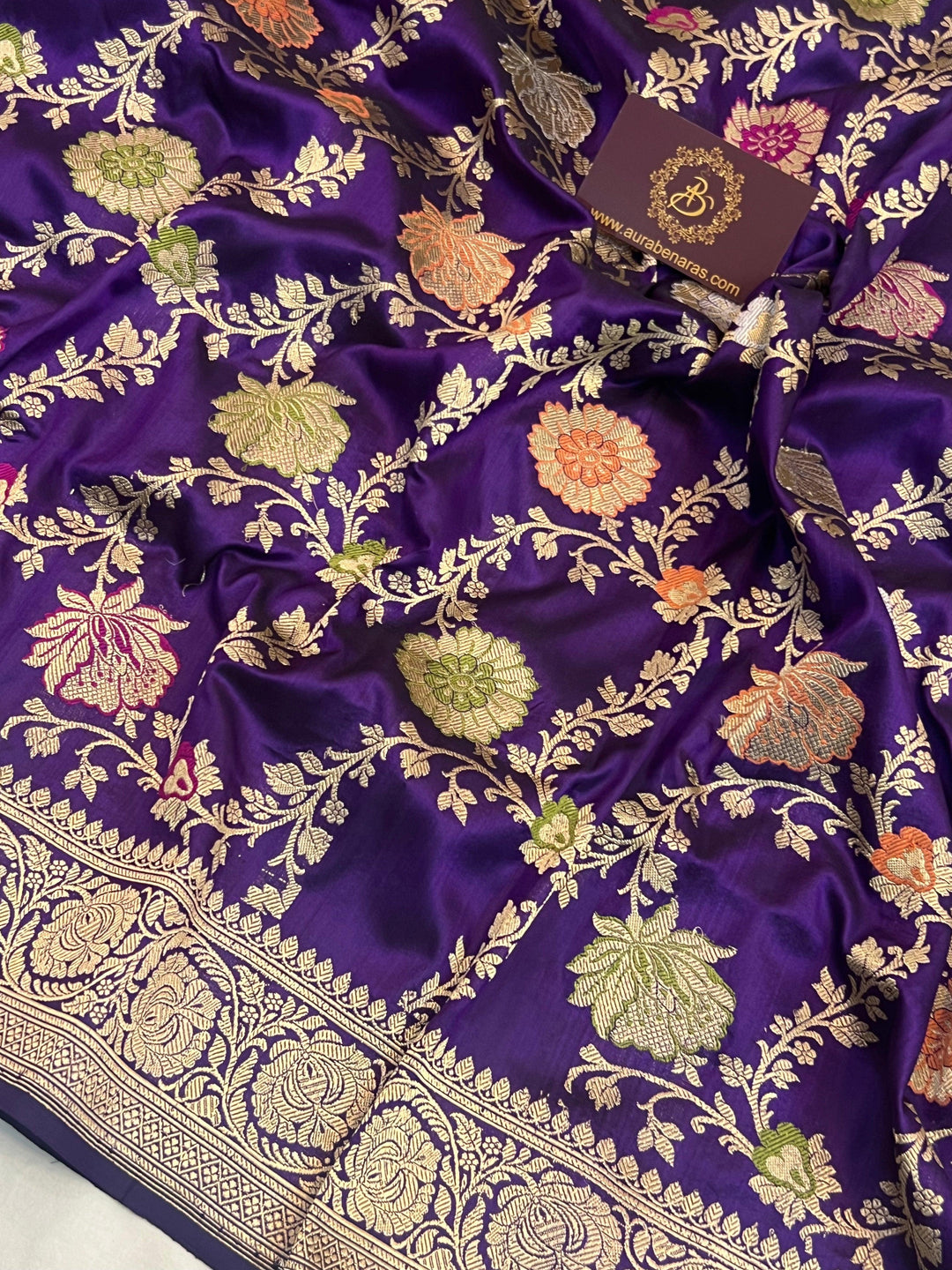 Close-up of detailed Kadhwa jaal weaving with floral motifs and vibrant Meenakari-inspired accents on pure Katan silk Banarasi saree