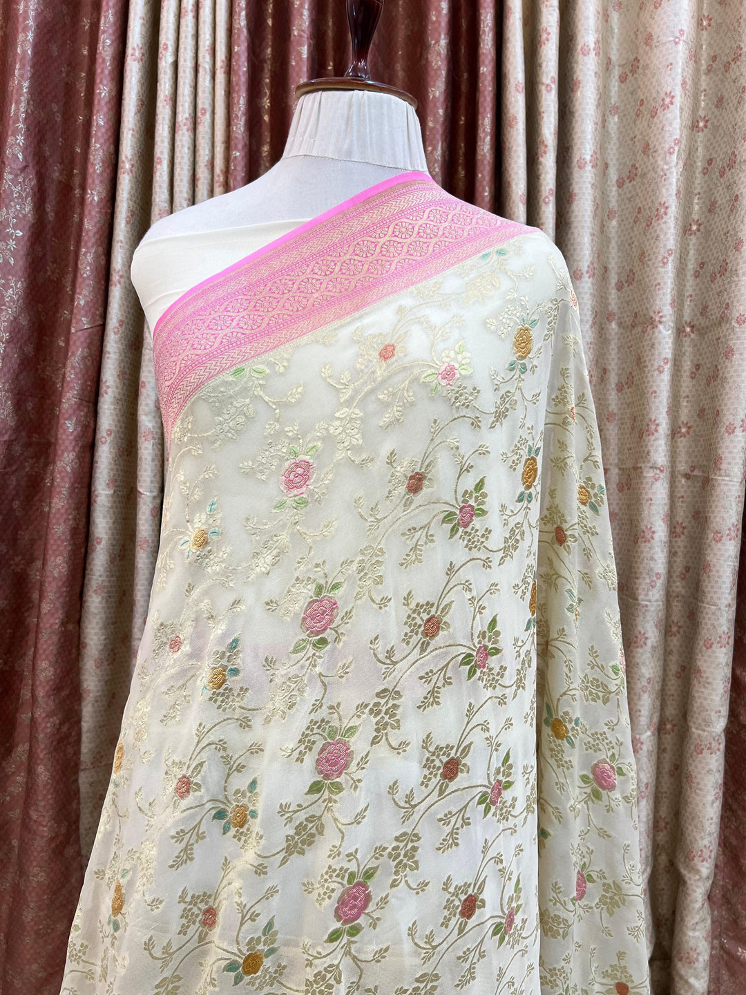 Pure Banarasi khaddi georgette saree draped with light golden zari jaal work and vibrant handbrush rangkaat motifs