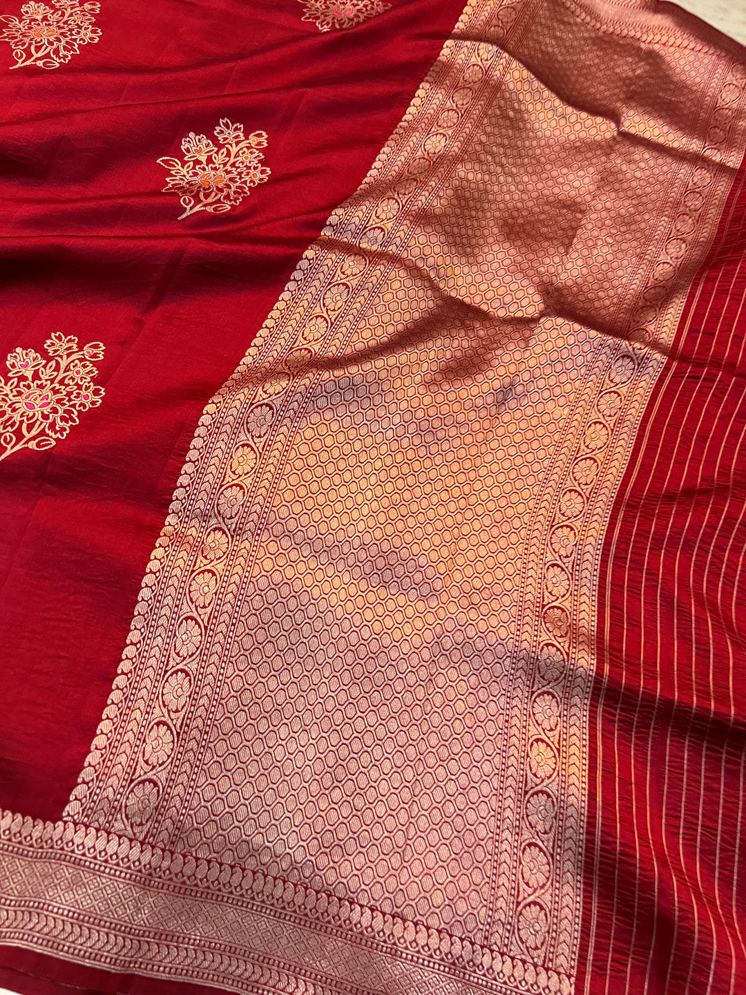 Rich pallu woven in golden zari on pure silk Banarasi saree with Meenakari butas